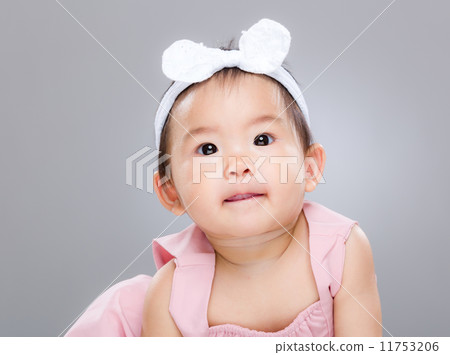 Adorable baby girl lick sticking out 11753206