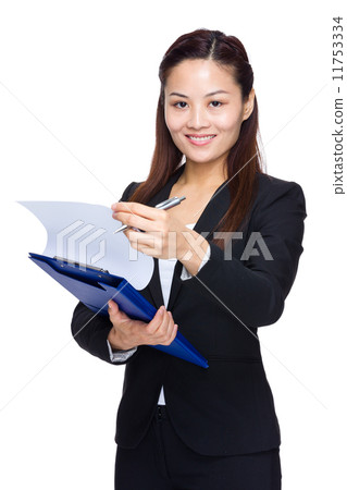 Businesswoman hold clipboard and look up paper document Businesswoman hold clipboard and look up paper document 11753334