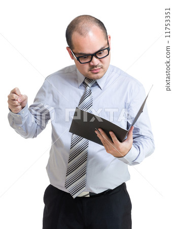 Angry business man look at report Angry business man look at report 11753351