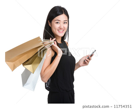 Asian woman with shopping bag and mobile phone Asian woman with shopping bag and mobile phone 11754351