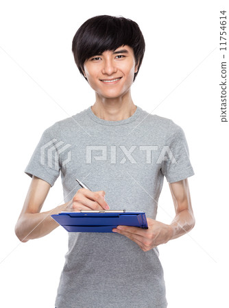 Young man take note on clipboard Young man take note on clipboard 11754614