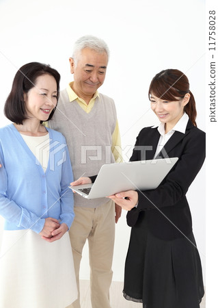A woman with a suit and a senior (middle) couple 11758028