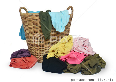 wicker basket and pile of colorful shirts wicker basket and pile of colorful shirts 11759214