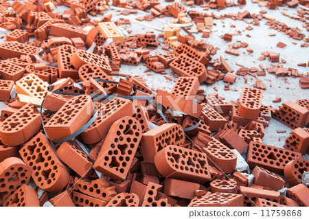 Pile of new intact and beaten bricks 11759868
