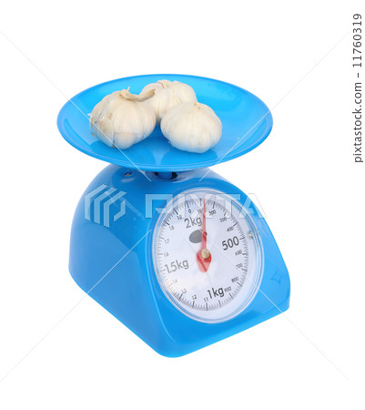 kitchen scales and garlic isolated on white background kitchen scales and garlic isolated on white background 11760319
