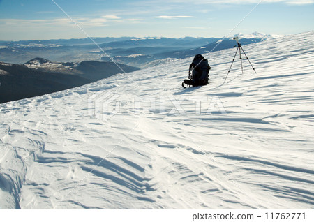 knapsack and tripod in winter mountains 11762771