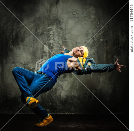 Man dancer in cap and jacket showing break-dancing moves Man dancer in cap and jacket showing break-dancing moves 11764446