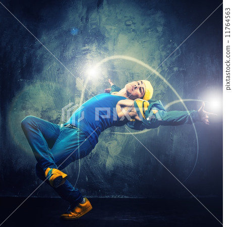 Stylish man dancer showing break-dancing moves with magic beams around him Stylish man dancer showing break-dancing moves with magic beams around him 11764563