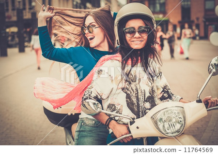 Multi ethnic girls on a scooter in european city 11764569