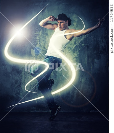 Stylish man dancer showing break-dancing moves with magic beams around him Stylish man dancer showing break-dancing moves with magic beams around him 11764658