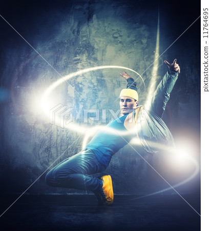 Stylish man dancer showing break-dancing moves with magic beams around him Stylish man dancer showing break-dancing moves with magic beams around him 11764695