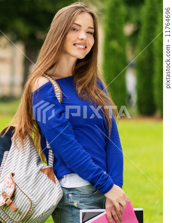Beautiful young student girl in a city park on summer day Beautiful young student girl in a city park on summer day 11764696