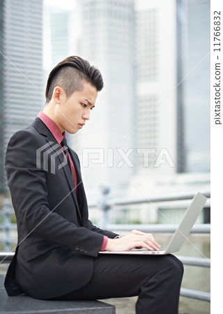 Businessman with Notebook in the City Businessman with Notebook in the City 11766832