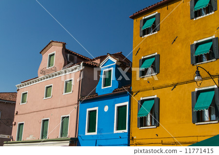 The row of colorful houses in Burano street, Italy. The row of colorful houses in Burano street, Italy. 11771415