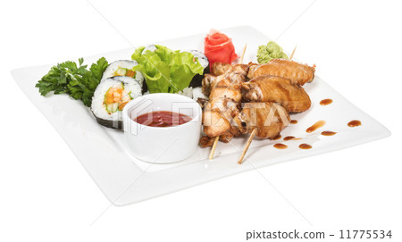 Buffalo chicken wings on plate with sushi 11775534