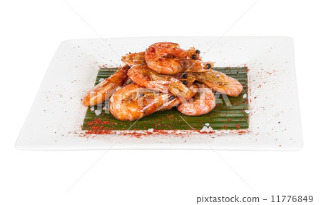 fried black tiger prawns with herbs and spices on banana leaf fried black tiger prawns with herbs and spices on banana leaf 11776849