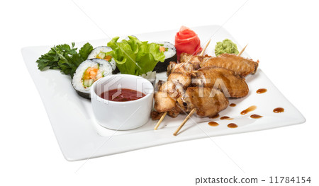 Buffalo chicken wings on plate with sushi Buffalo chicken wings on plate with sushi 11784154