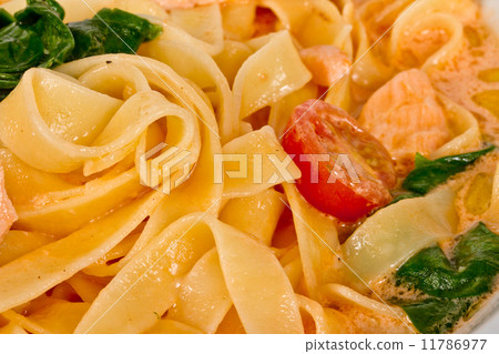tasty pasta with cream, salmon, cheese and parsley close up tasty pasta with cream, salmon, cheese and parsley close up 11786977
