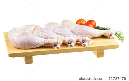 Fresh raw chicken wings on chopping board with roma tomatoes 11787476