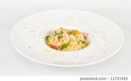 photo of delicious risotto dish with herbs and tomato on white b 11791485