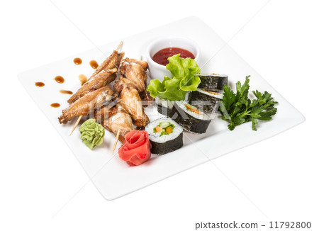 Buffalo chicken wings on plate with sushi 11792800