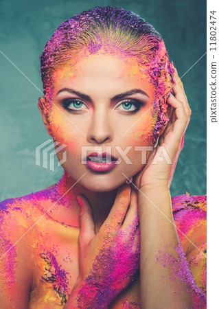 Beautiful young woman with conceptual colourful body art 11802474