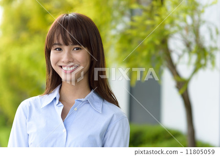Portrait of successful young office lady smiling along promenade shallow dept of field Portrait of successful young office lady smiling along promenade shallow dept of field 11805059