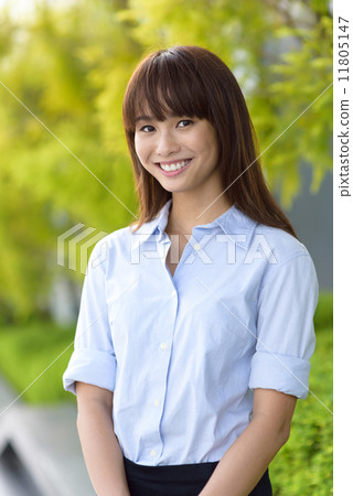 Portrait of successful young office lady smiling along promenade shallow dept of field Portrait of successful young office lady smiling along promenade shallow dept of field 11805147