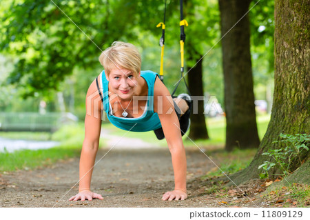 woman doing suspension sling trainer sport 11809129