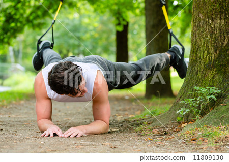 man doing suspension trainer sling sport 11809130