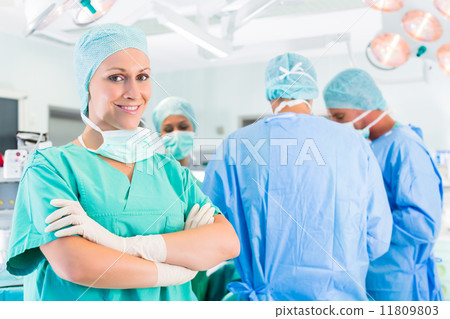 Surgeons operating patient in operation theater 11809803