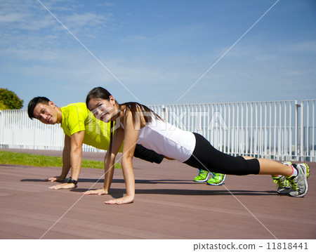 Young Asian Adults doing push ups 11818441