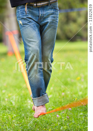 Slack line in the city park. Slack line in the city park. 11822639