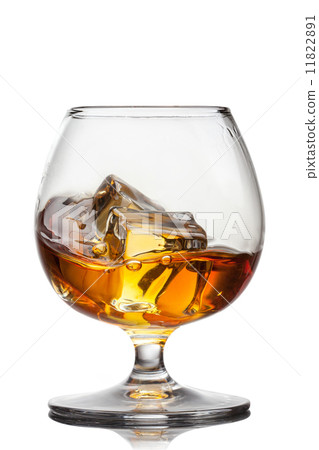 Splash of whiskey with ice in glass isolated 11822891