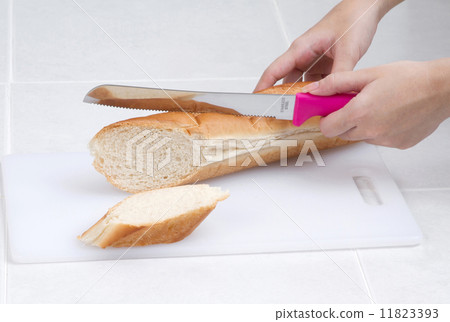 woman slicing bread with knife 11823393