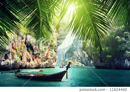 long boat and rocks on beach in Krabi, Thailand 11824400