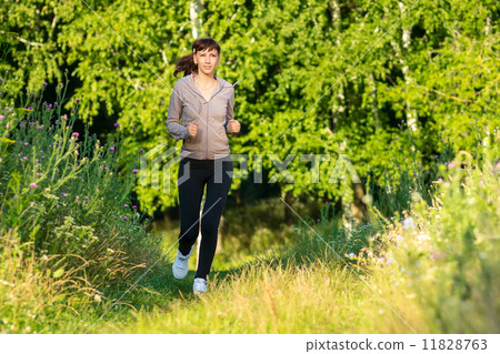 Young woman jogging in summer morning park Young woman jogging in summer morning park 11828763