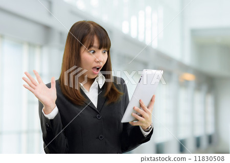 A woman's business scene standing in a modern building 11830508