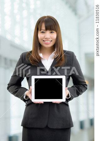 A woman's business scene standing in a modern building A woman's business scene standing in a modern building 11830516