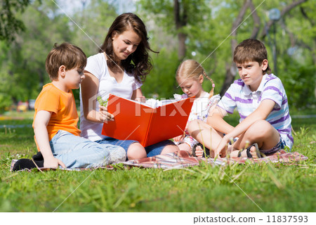 teacher reads a book to children in a summer park teacher reads a book to children in a summer park 11837593