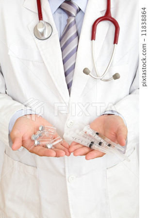 A doctor's hand holding injector 11838864