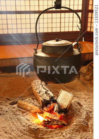 warm Japan teapot with fire 11839521