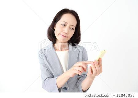 A woman who manipulates a smartphone with a troubled face 11845055