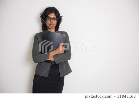 indian business woman with serious look and plain background indian business woman with serious look and plain background 11845168