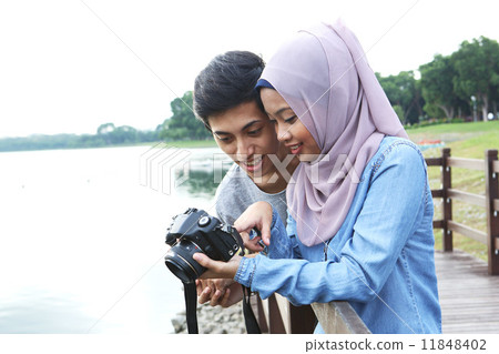 Asian couple taking pictures at the park 11848402