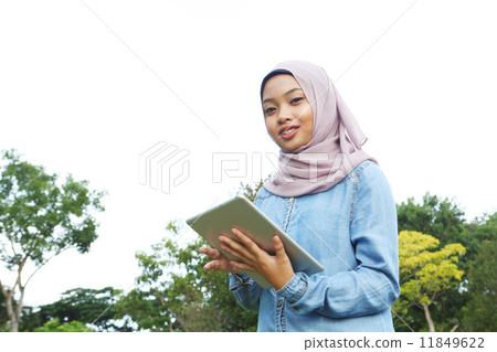 使用片劑的亞裔女孩在公園 使用片劑的亞裔女孩在公園 11849622