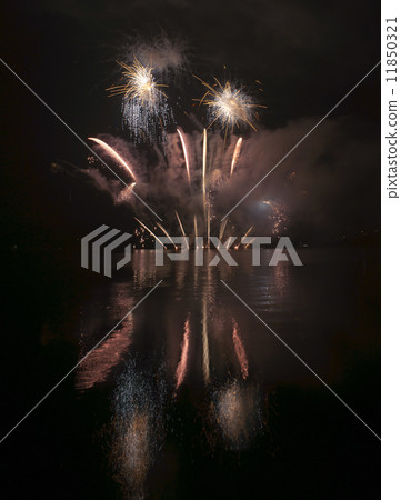 Colorful fireworks on black sky background with water reflection 11850321