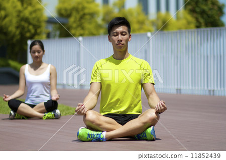 Young Asian Adults practising yoga in the city Young Asian Adults practising yoga in the city 11852439