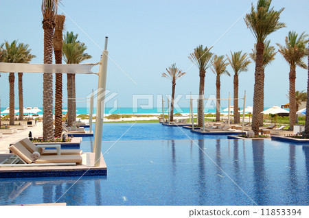 Huts at swimming pool of the luxury hotel, Saadiyat island, Abu Huts at swimming pool of the luxury hotel, Saadiyat island, Abu 11853394