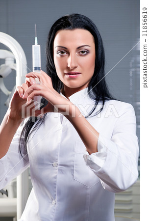 Attractive woman with medical syringe Attractive woman with medical syringe 11856619